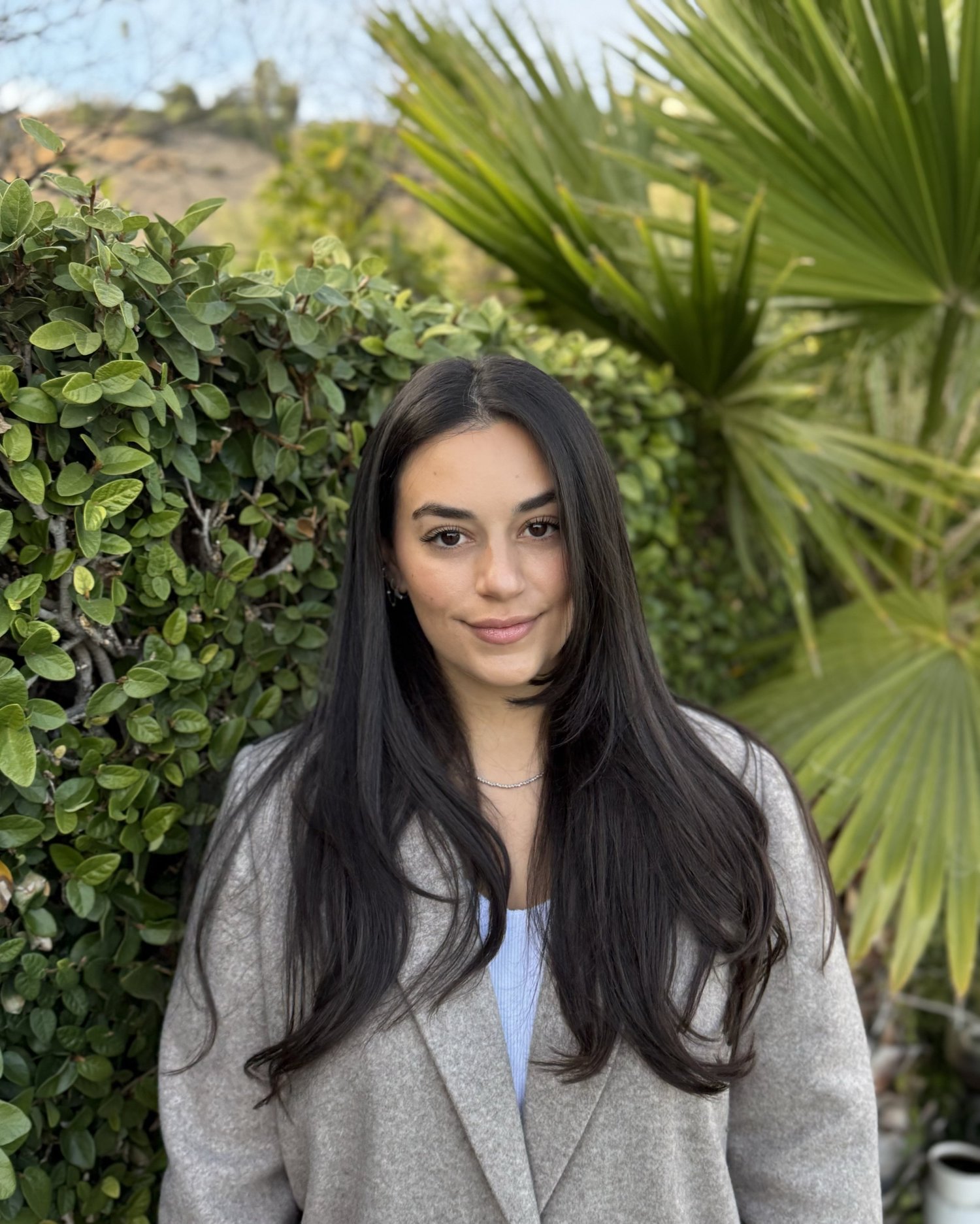 Shaked Ben, licensed marriage and family therapist, smiling in a garden